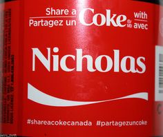 a close up of a bottle of coke with the word nicholas on it's label