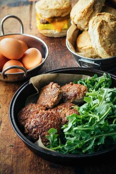 some food is sitting on a table with bread and eggs in the bowl next to it