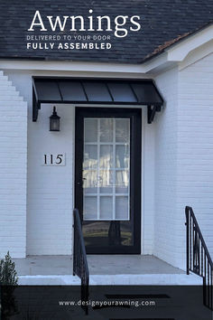 the front door of a white house with black trim and awnings on it