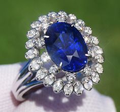 A Breathtakingly Striking HANDMADE 14k White Gold Ring with Beautiful Oval Cut Sapphire in Blue color! The GEM is 3.31CT and measures 10.05x7.23x5.77 mm! This Stone will take your breath away, especially on the sunlight! You will want to look at this stone endlessly. The mounting is a masterpiece! HANDMADE 14K White Gold Diamond Mounting (tested), that was is custom made to Accommodate this Beauty of a Gem in a V-prongs setting! Super FINE Workmanship on the Diamond v-split setting with 32 pcs Brilliant Full Cut Diamonds in GH color, SI1 clarity, totaling to approx  0.49CT ! Fabulous Braided Band and Diamond Gallery! The Entire Top's outline is 17.3x14.7 mm- HUGE. The Ring weights 6.4 g, nice and SOLID. Sits 8.6 mm off the top of the finger. Finger size 7(Free Re-sizing with purchase). Cen Luxury Oval Platinum Gemstones, Gia Certified Sapphire Cluster Jewelry, Exquisite Oval Brilliant Cut Gemstones, Exquisite Oval Brilliant-cut Gemstones, Exquisite Oval Platinum Gemstones, Elegant Oval Gia Certified Gemstones, Luxury Oval Gemstones With Halo Setting, Gia Certified Oval Gemstones For Fine Jewelry, Dazzling Oval Sapphire Gemstones