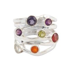 Channel the properties and power of multiple gemstones with the help of this spectacular ring designed by India's Bhavya Jain. The artisan uses a colorful sextet of amethyst iolite garnet peridot carnelian and blue topaz gemstone to decorate the ring's sterling silver band which undulates elegantly around the stones. Purple Multi-stone Amethyst Ring, Silver Multi-stone Amethyst Ring, Multicolor Multi-stone Amethyst Ring Gift, Multicolor Multi-stone Amethyst Jewelry, Multicolor Multi-stone Amethyst Ring In Sterling Silver, Rainbow Water, Multi Band Ring, Topaz Gemstone, Sterling Silver Bands