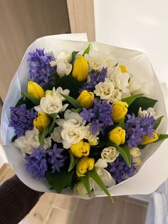 a bouquet of yellow and white tulips, purple and white crocsant