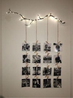 several pictures are hung on the wall with twine and lights strung from each string