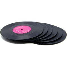 six black vinyl records stacked on top of each other with pink labels in the middle