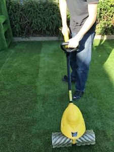 a man is using a lawn mower on the grass