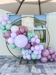 there is a balloon arch in front of the window