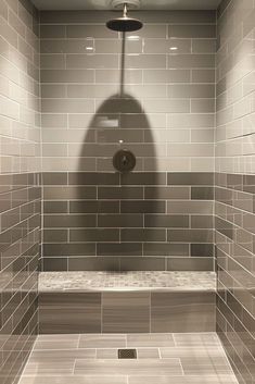 the shadow of a person in a tiled shower