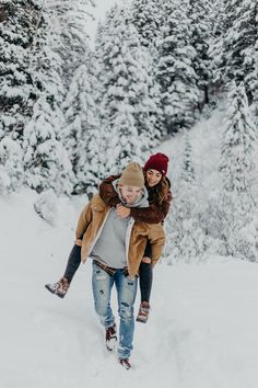 a man carrying a woman in the snow