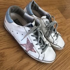 Golden Goose Superstar Sneakers With Pink Star Glitter And Baby Blue Tab. Size 36 Like Us Size 6.5. Bought On The Modist For Over $500. The Leather Came Apart On The Left Sneaker Tab But Should Be A Easy Fix For A Cobbler, Otherwise In Excellent Used Condition. Shoes Golden Goose, Golden Goose Superstar, Glitter Sneakers, Pink Star, Pink Stars, Golden Goose, Cobbler, Womens Shoes Sneakers, Baby Blue