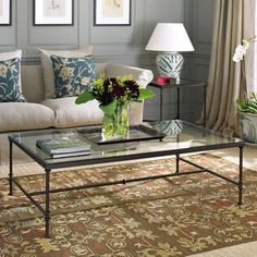 a living room with two couches, a coffee table and pictures on the wall