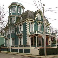 an old victorian style house painted green and white