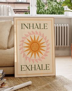 an inhale exhale sign sitting on top of a rug next to a couch