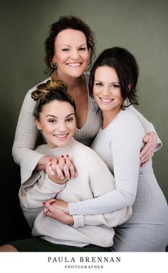 three women are hugging and smiling for the camera