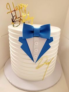 a birthday cake with a bow tie and glasses on it's top tier is shown