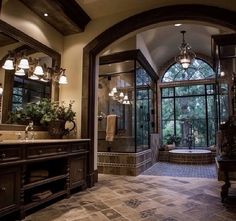 a large bathroom with an arched window and stone flooring is pictured in this image