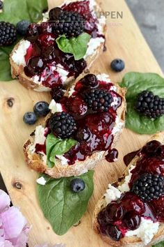 some bread with berries and spinach on it