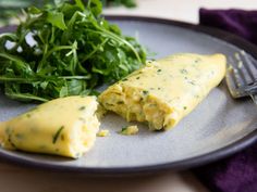 an omelet and some greens on a plate