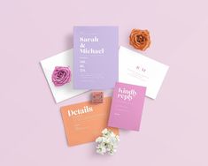 wedding stationery with flowers on pink and purple background, including two matching envelopes