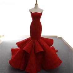 a red dress on display in front of a window