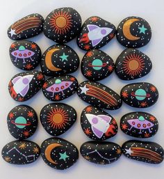 a pile of painted rocks sitting on top of a white table