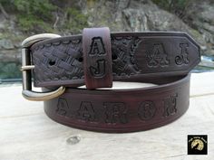 a leather belt with the word arr on it