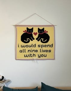 a wall hanging with two cats on it and the words i would spend all nine lives with you