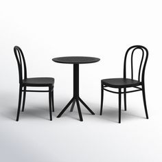 two black chairs and a table with one chair next to the table, on a white background