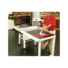 a man is using a sanding machine on a table