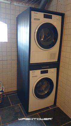 two washers stacked on top of each other in a room with tile flooring