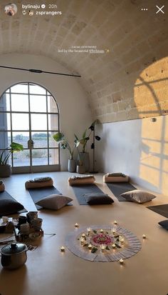 a room with yoga mats and candles on the floor