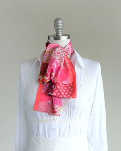 "Make a bold, happy statement with this soft oblong chiffon scarf. Style it around your neck or in your hair. Find styling examples in the last photo. Ready to ship and comes nicely wrapped in our gift-ready faces print cotton pouch. They are constructed entirely by hand with love and attention to every detail.  color mix I've got all the hottest pinks covered in this print with a salmon pink side stripe and a few colorful jewel tones mixed in. size + details 10 x 54 inches long (26mm x 137mm) shown on a 13\"/33mm (size 10) mannequin neck more details + carefully stitched in two layers of super-soft airy chiffon polyester + two-sided closed-seam construction, completely handmade + easy to style, wrinkle-free + small C.Banning logo shows on one side + comes nicely wrapped in a fun faces pri Pink Patchwork, Bow Scarf, Cotton Pouch, Scarf Style, Reusable Pouches, Pink Chiffon, Patchwork Print, Fashion Scarf, Color Mix