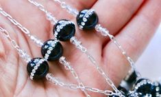 "This incredible sparkling Black Onyx and Rhinestone Wedding Lasso design is new to my family of rosaries!! The traditional Wedding Cord is also known as the Wedding Lasso or a Wedding Lazo. It is used during a Christian Catholic wedding ceremony. A figure-eight shape is placed around the neck areas of the bride and groom after they have made their wedding vows...showing the couple's love has no beginning or end. The number eight in the Bible is also the number of new beginnings. This Lasso symb Black Crystal Embellished Jewelry For Wedding, Spiritual Crucifix Necklace For Wedding, Black Crystal Embellished Wedding Jewelry, Handmade Wedding Rosary With Cross Shape, White 8mm Beads Wedding Rosary, Black Onyx Rosary As A Gift, Wedding Lazo, Wedding Lasso Catholic, Wedding Cord