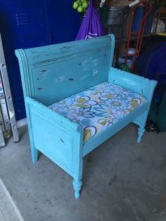 an old blue bed frame with a floral print pillow on it in a storage room