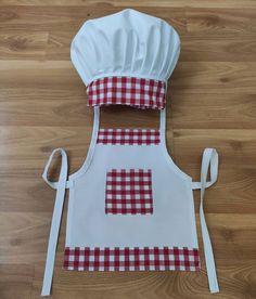 a chef's apron with red and white checkered squares on it