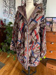 This vintage Missoni Sport cardigan is a one-of-a-kind piece that will elevate any outfit. The colorful geometric pattern and hooded feature make it perfect for both casual and party occasions. Made from high-quality wool and knit fabric, it is durable and comfortable to wear. The long-sleeved sweater has a regular fit and features button accents. The Missoni brand is known for designer clothing, and this cardigan is no exception. It is a must-have for anyone who loves the '90s vintage style. Ma Vintage Missoni, Colorful Geometric Pattern, Love The 90s, Sterling Silver Choker, Choker Collar Necklace, Sleeved Sweater, Most Beautiful Dresses, Knitted Hood, Antique Clothing