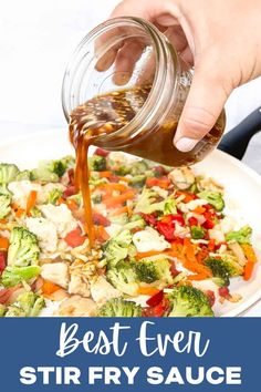 the best stir fry sauce is being poured into a white plate with broccoli, carrots and cauliflower