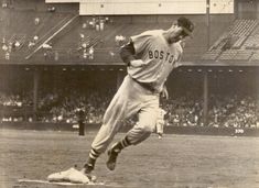 an old photo of a baseball player in the middle of his run to first base