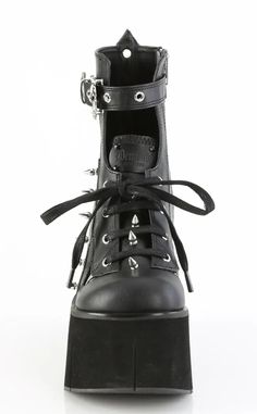 The Kera series features an impressive platform wedge across a range of styles to suit everyone who wants to tower over the competition. Vegan Black PU leather 4 1/2" Inch (114mm) Platform Lace-Up Front Ankle Boot Featuring Top Skull Buckle Strap & Metal Spike Stud Details Inner Side Metal Zip Closure U.S women's sizing-refer to size chart for more info High Heel Platform Moto Boots In Faux Leather, Leather Platform Boots With Chunky Wedge Heel, Edgy High Heel Wedge Boots With Chunky Platform, High Heel Leather Moto Boots For Alternative Fashion, Gothic Leather High Heel Platform Boots, Edgy Wedge Boots With Chunky Platform, Gothic Chunky Platform Leather Heels, Gothic Leather Heels With Chunky Platform, Leather Platform Heels For Streetwear