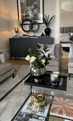 a living room filled with furniture and a large mirror on the wall above it's coffee table