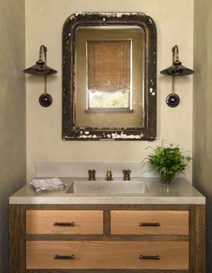 a bathroom vanity with two sinks and a large mirror above it, in an instagram