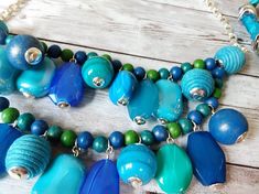 Blue Costume Jewelry With Colorful Beads, Blue Wooden Beads For Jewelry Making, Adjustable Blue Necklace With Wooden Beads, Blue Wooden Beads Jewelry For Jewelry Making, Blue Beaded Necklace With Dangling Beads, Blue Jewelry With Dangling Round Beads, Blue Beaded Necklace For Costume Jewelry, Blue Costume Jewelry Necklace With Dangling Beads, Blue Beaded Necklace With Dangling Beads For Costume Jewelry