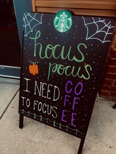 a sign that says focus pocuss i need go to focus coffee on the sidewalk