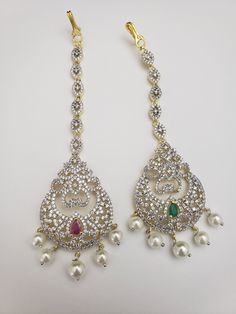 "Handmade Indian Temple Jewelry, best to wear it for traditional ceremonies or Indian wedding. This bridal jewelry has an ethnic finish. It has Cubic Zircon stones with ruby. It is a Bollywood style one gram jewelry. There are long and short patterns of Indian jewelry in Kundan, Pearls, CZ, American Diamond, ruby, emerald, Polki, kemp to suit every occasion of South Indian and North Indian weddings. When you adorn mang tikka on your forehead and it will steal the show. The Mang Tikka has Semi-pr Traditional Hand Set Tikka For Eid, Silver Temple Jewelry Tikka For Eid, Bollywood Style Tikka With Stone Work For Rituals, Traditional Adjustable Jewelry With Stone Work, Traditional Jeweled Tikka For Festive Occasions, Traditional Jeweled Tikka For Festive Season, Traditional Adjustable Tikka With Stone Work, Traditional Adjustable Jewelry For Eid, Bollywood Style Tikka For Rituals With Intricate Design