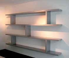 a wall mounted shelf with two lights on each side and one light at the top