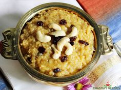 a bowl filled with oatmeal and nuts on top of a napkin next to a flower