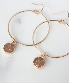 Take your Hoop game to the next level with our Rey Druzy Hoop Earrings. This modern design incorporates our top selling Gwen Hoops with the added detail of sparkling round Druzy drops. 14k Gold Fill Hoops are hand forged with light hammered texture for extra shimmer. CUSTOMIZE by selecting the exact Druzy drops you love! See photos for current options. Measurements: 2.5" L x 1.75" W Materials: Natural Druzy Stones | 14k Gold Fill Hoop, Ear wires Origin: Handcrafted in FloridaStyle: REYE01 Hoop Games, Wire Bending, Indigo Design, Jewelry 2023, Florida Style, Gold Filled Hoops, Jewelry Photography, Top Gifts, Top Selling