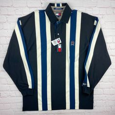 A Vintage Original 1990’s Tommy Hilfiger Striped Polo Long Sleeve Shirt. In A Men’s Size Large. Brand New With Original Tags. Please Message With Any Questions And Thanks For Looking. -Measurements Are Shown In The Photos- Retro Long Sleeve Navy Top, Navy Retro Long Sleeve Top, Navy Long Sleeve Retro Tops, 90s Striped Long Sleeve Tops, Vintage Navy Long Sleeve Tops, Blue 90s Style Tops For Fall, Vintage Navy Top For Fall, Navy Retro Top For Fall, Long Sleeve Rugby Shirts