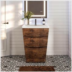 a bathroom with a sink, mirror and rug on the floor in front of it