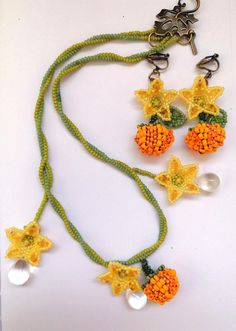 My first design for Halloween for this year! A whimsical pair of earrings and an ethereal necklace to match, inspired by the pumpkin patches that we all love! Elegant pumpkin blossoms, plump pumpkins, and vines, ready to be worn during your autumn promenades!  They are entirely made by hand with premium quality miyuki and duo glass beads, fireline thread, and the hooks of your preference. Whimsical Handmade Beaded Dangle Necklaces, Handmade Fairycore Beaded Necklaces, Cute Handmade Orange Jewelry, Cute Orange Handmade Jewelry, Cute Orange Beaded Jewelry, Cute Orange Flower Shaped Jewelry, Cute Orange Flower Jewelry, Cute Orange Flower-shaped Jewelry, Flower-shaped Orange Jewelry For Festivals