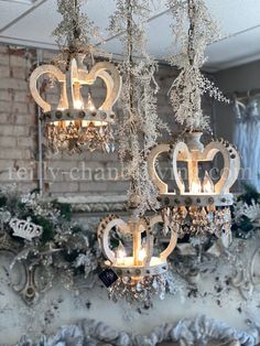 three chandeliers hanging from the ceiling in front of a brick wall and window